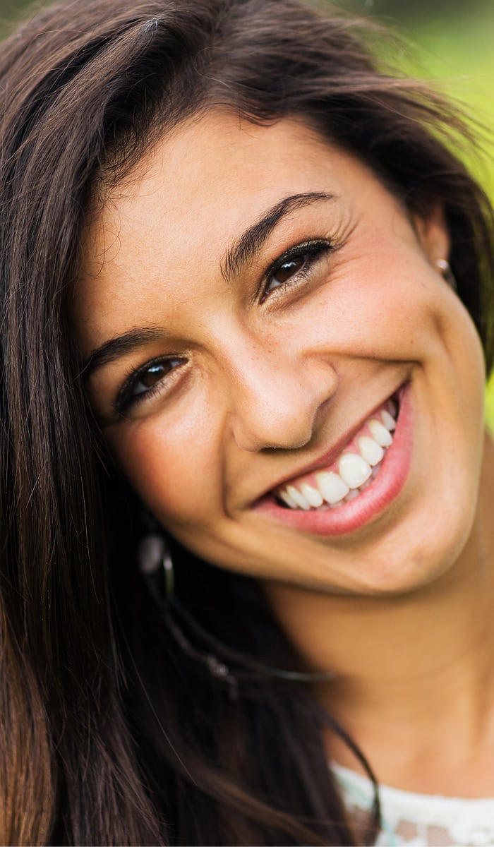 Image of a young woman smiling to promote the Bioclear process